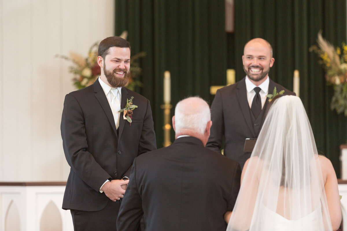 The groom is overcome with emotion seeing his bride walk  down the isle.