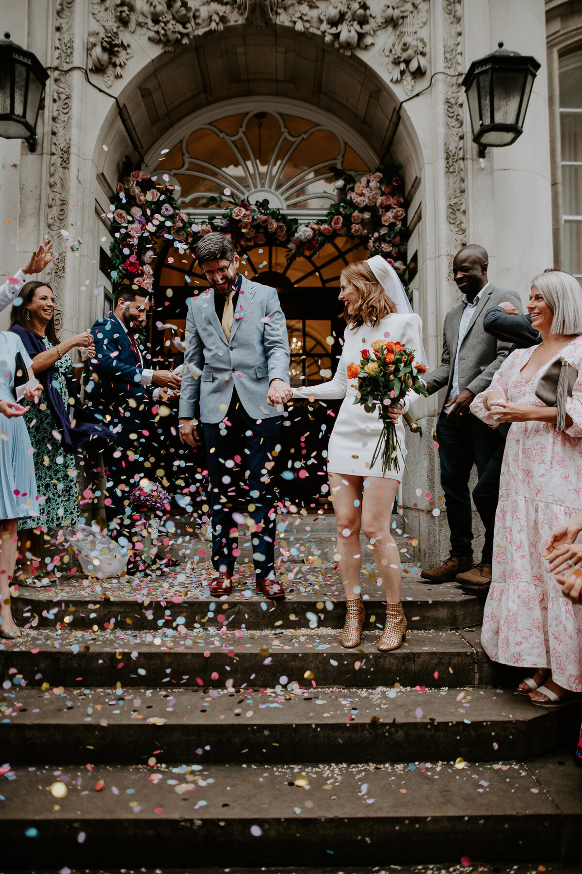 A couple exit their ceremony at Chelsea Town Hall to a shower of confetti. The confetti exit shot at Chelsea Town Hall is a very famous shot for every couple and has been done for years.