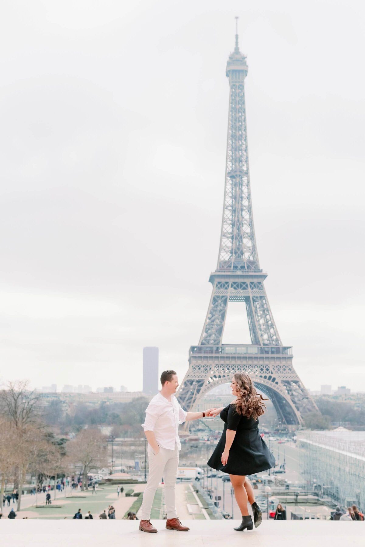 couple dancing in front of the Eiffel tower