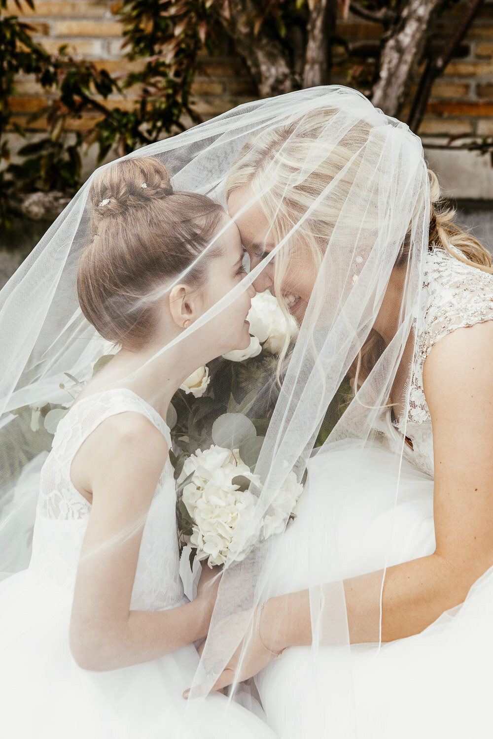Bride and flower girl under wedding veil in Buffalo, New York