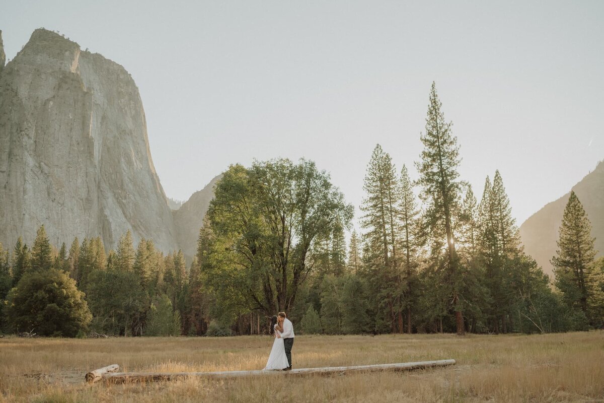 couple embracing in front of mountainscape