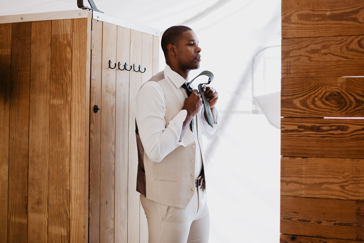 Utah Elopement Photographer captures groom getting dressed before elopement