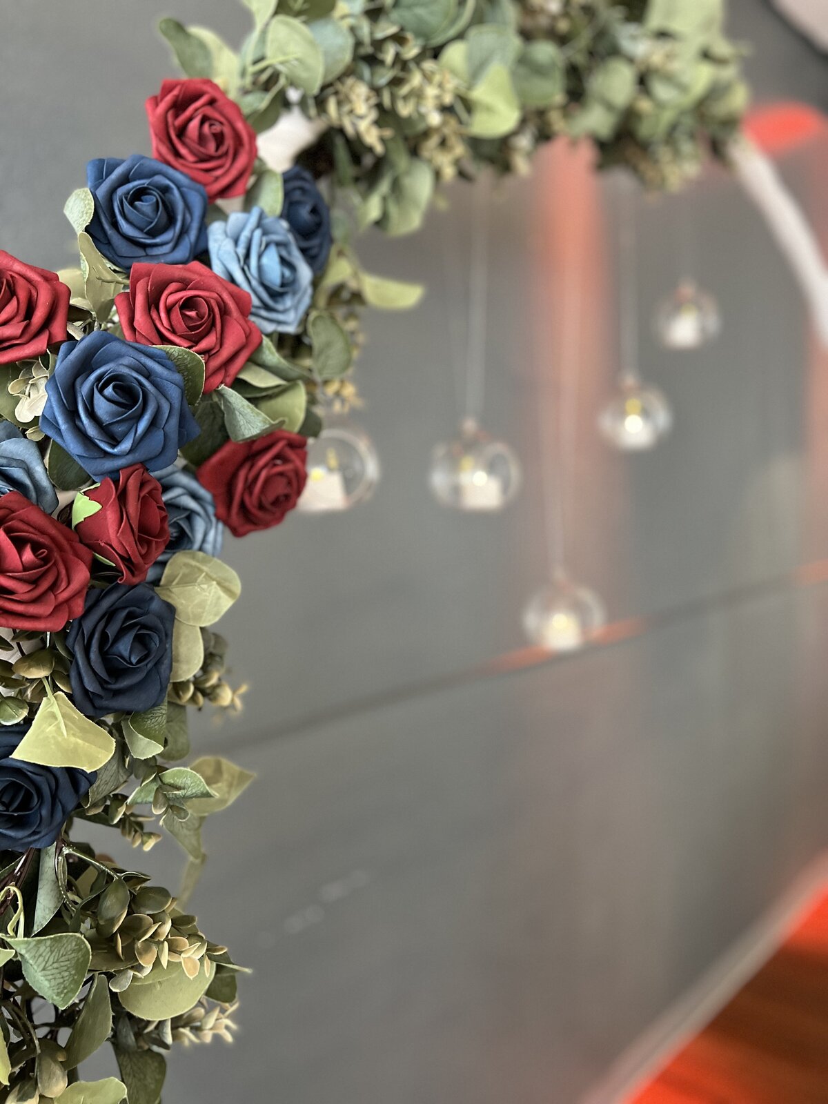 Timeless wedding circle arch adorned with roses and glass orbs - A captivating backdrop for traditions at The District, Clearwater, Florida