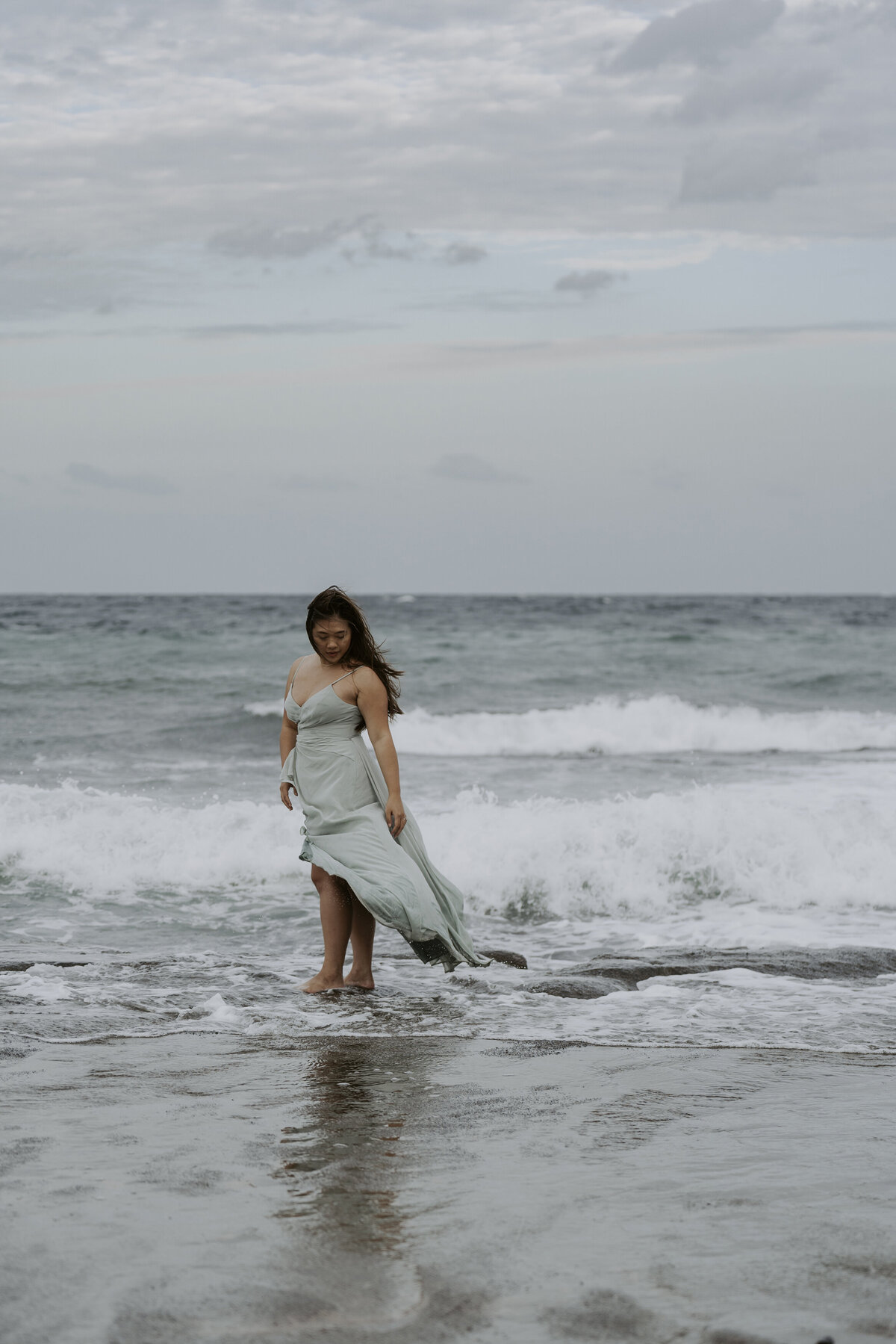 the bride wets her feet in the sea of jeju island