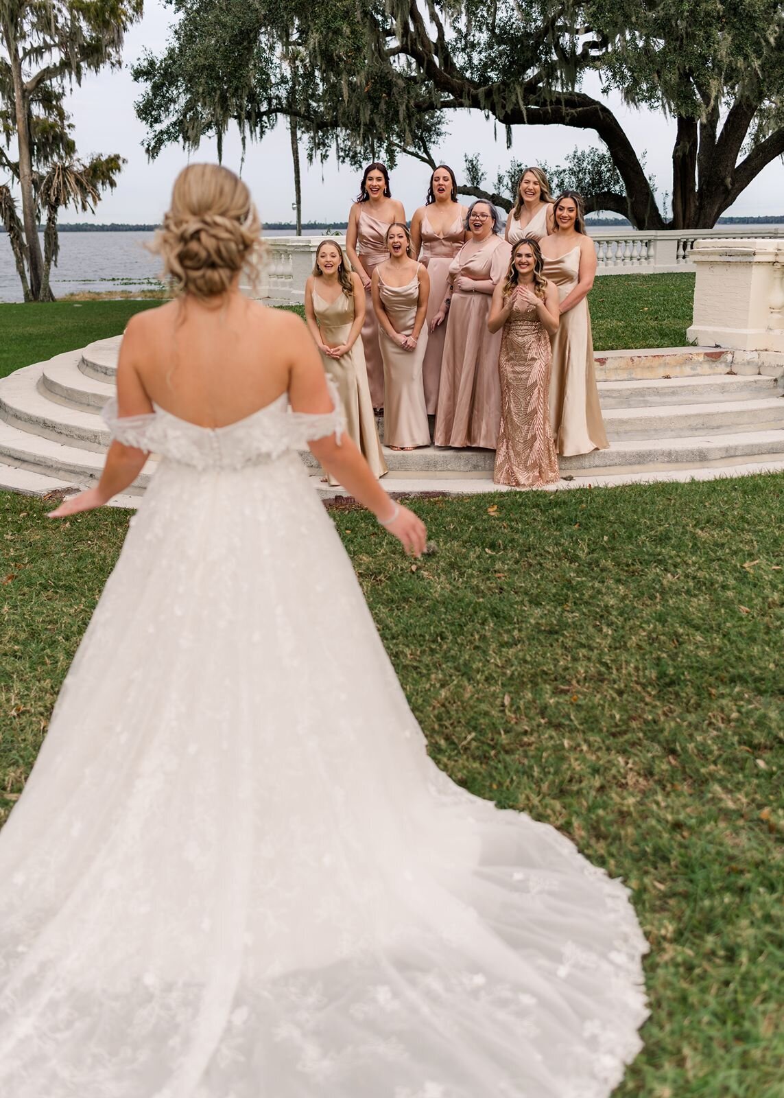Bridesmaids first look on stairs at Bella Cosa, Lake Wales, Florida