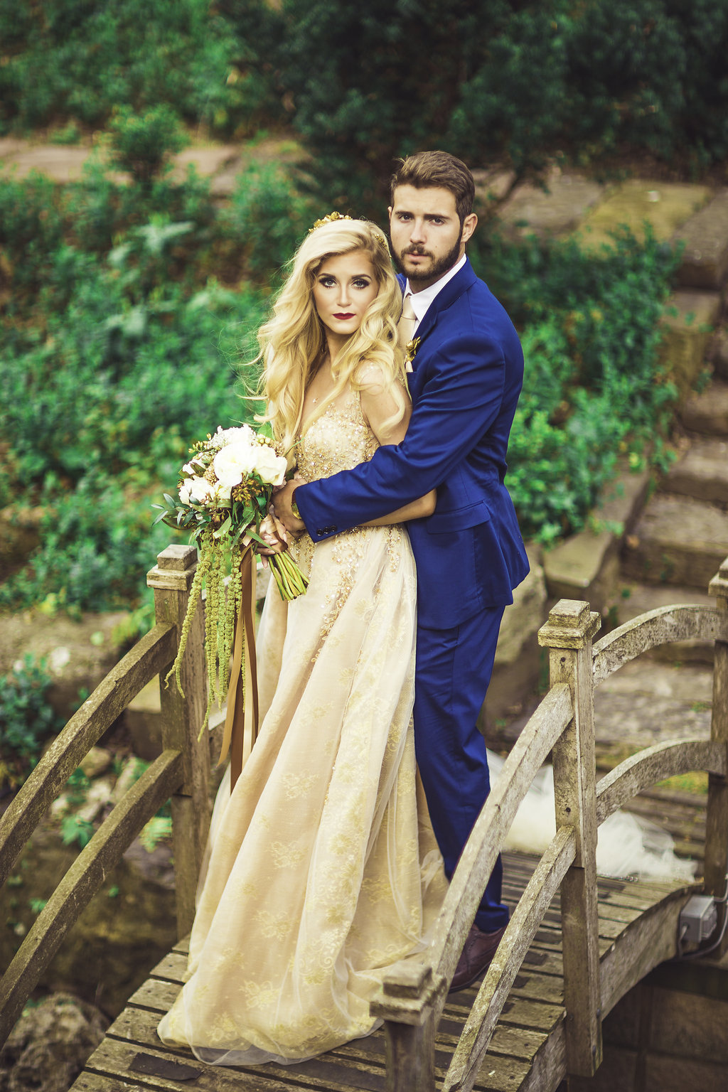 Wedding Photograph Of Bride in Peach Dress and Groom in Blue Suit Posing for a Camera Shot Los Angeles