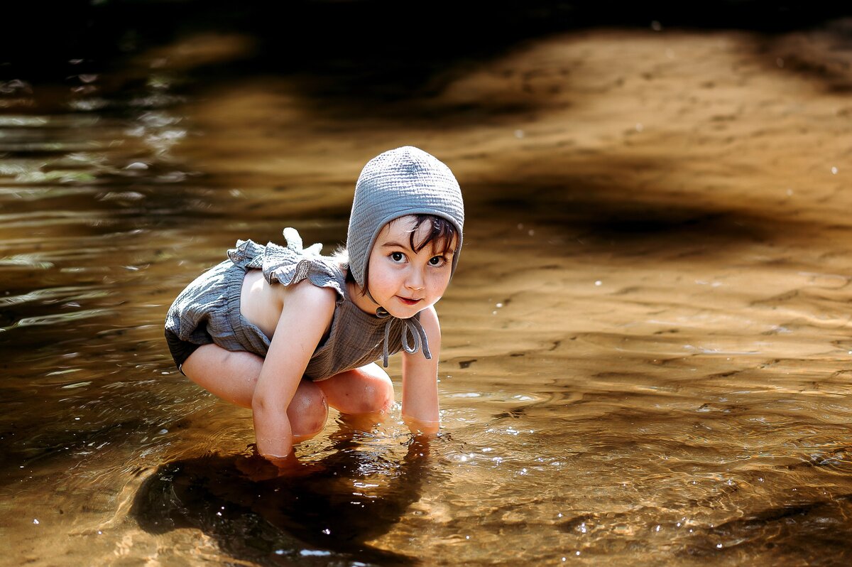 Child splashing in creek McKennaPattersonPhotography