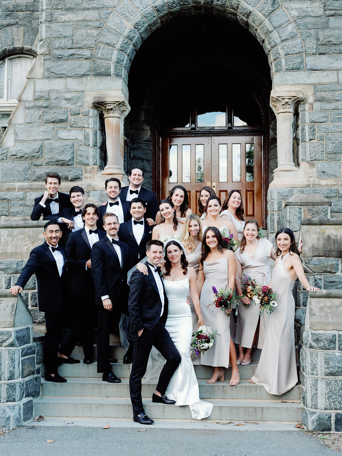 Couple poses in front of georgetown DC with bridal party