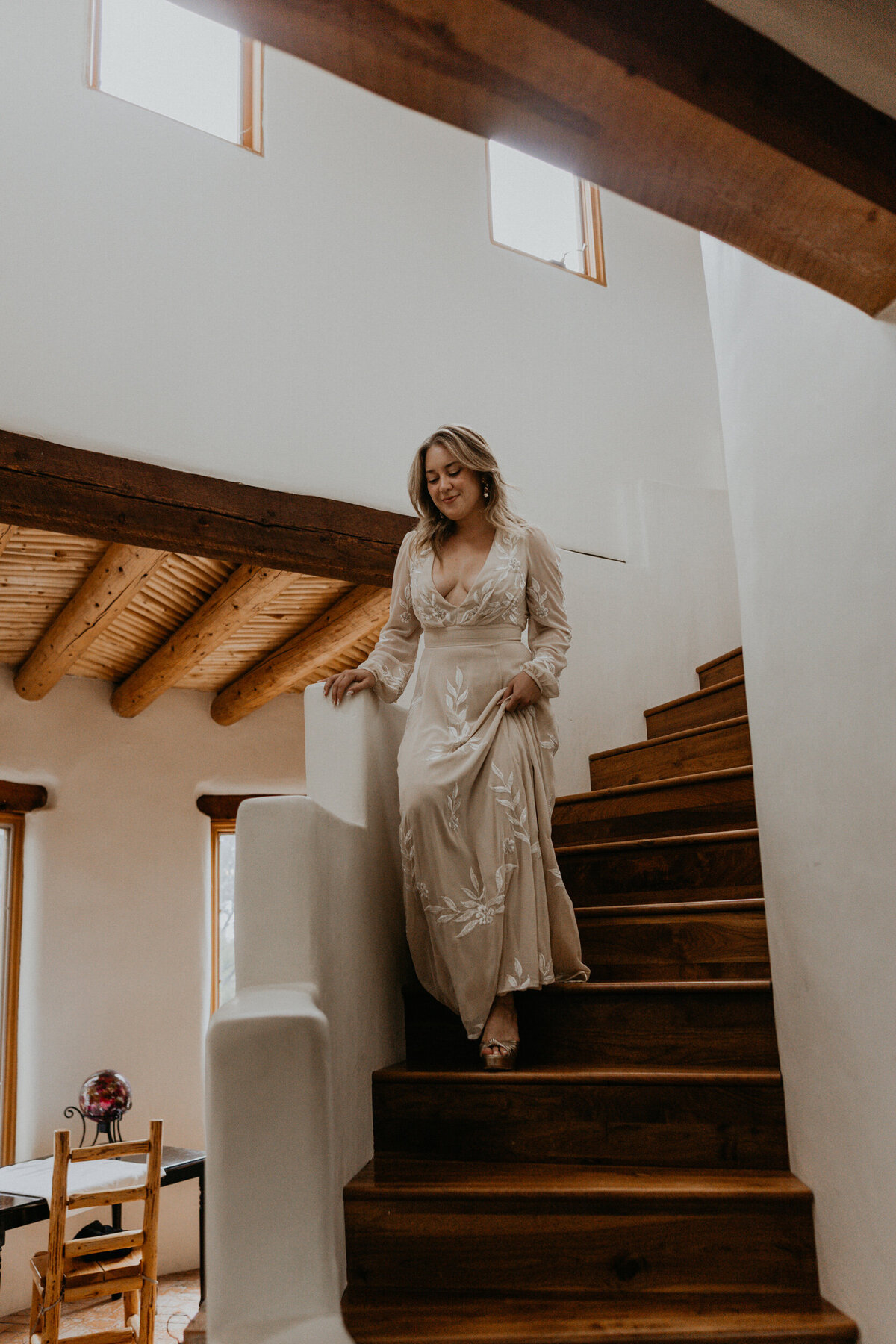 bride walking down stairs in a southwest home
