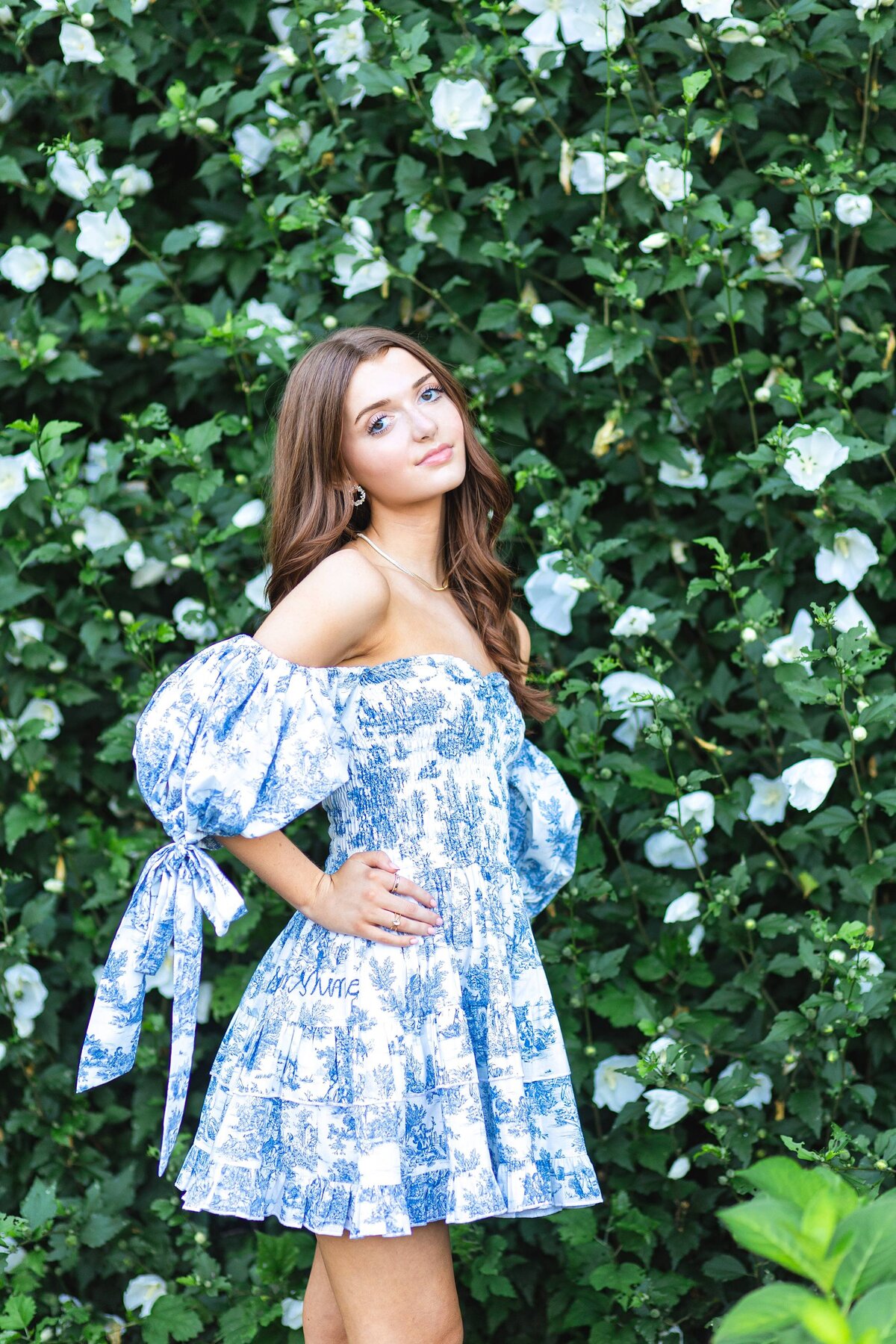 girl posing in boutique dress at flower garden