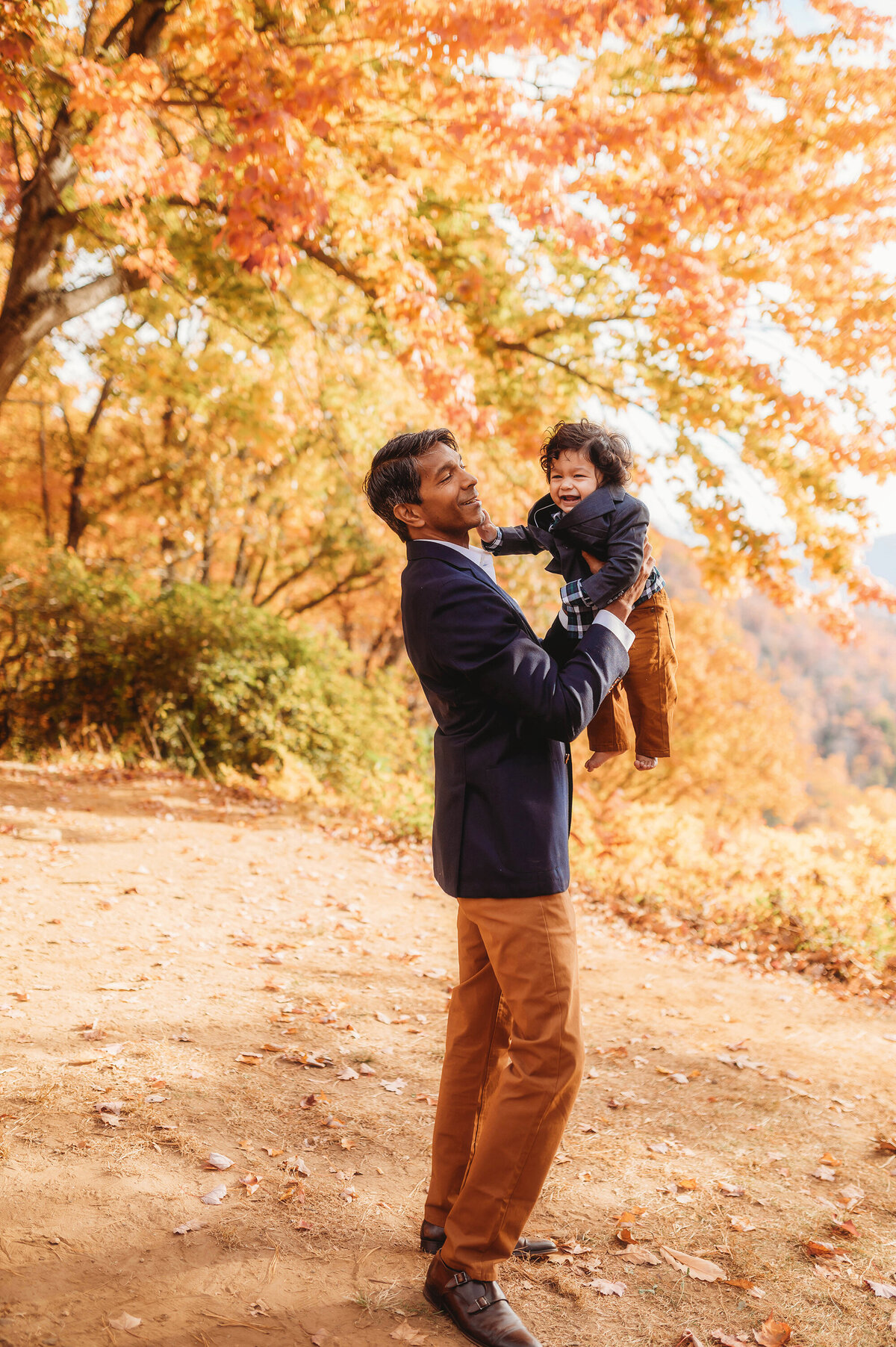 Father plays with his son during their Family Photoshoot on the Blue Ridge Parkway in Asheville, NC.