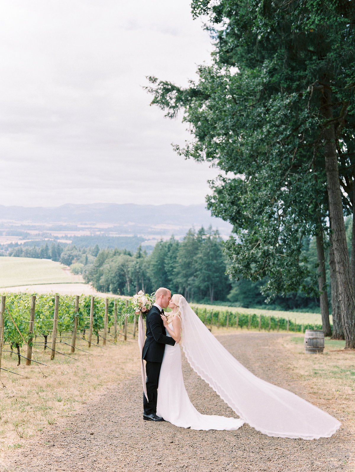 bride and groom kissing at vista hills vineyard