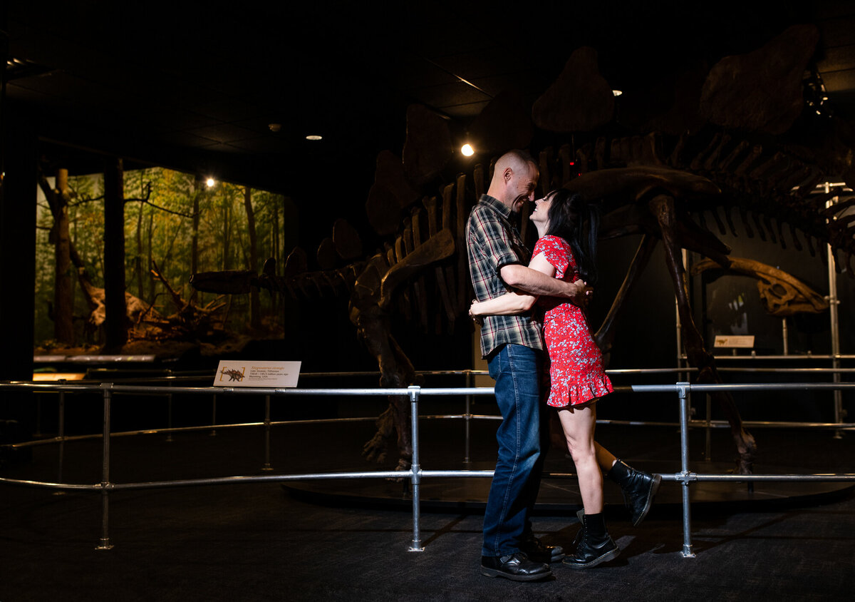 Couple snuggles in the dino exhibit at COSI