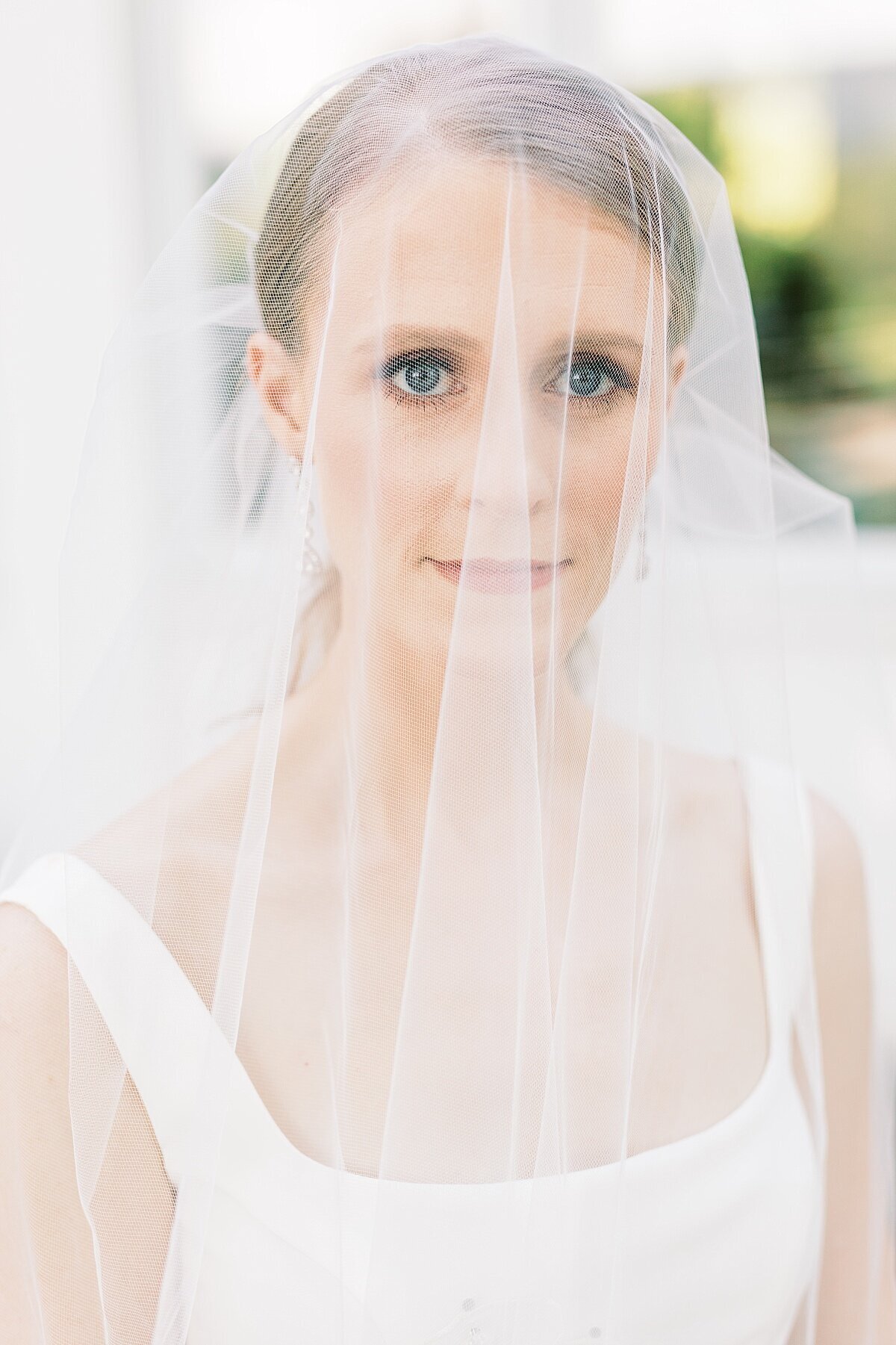 bride with veil in front of face