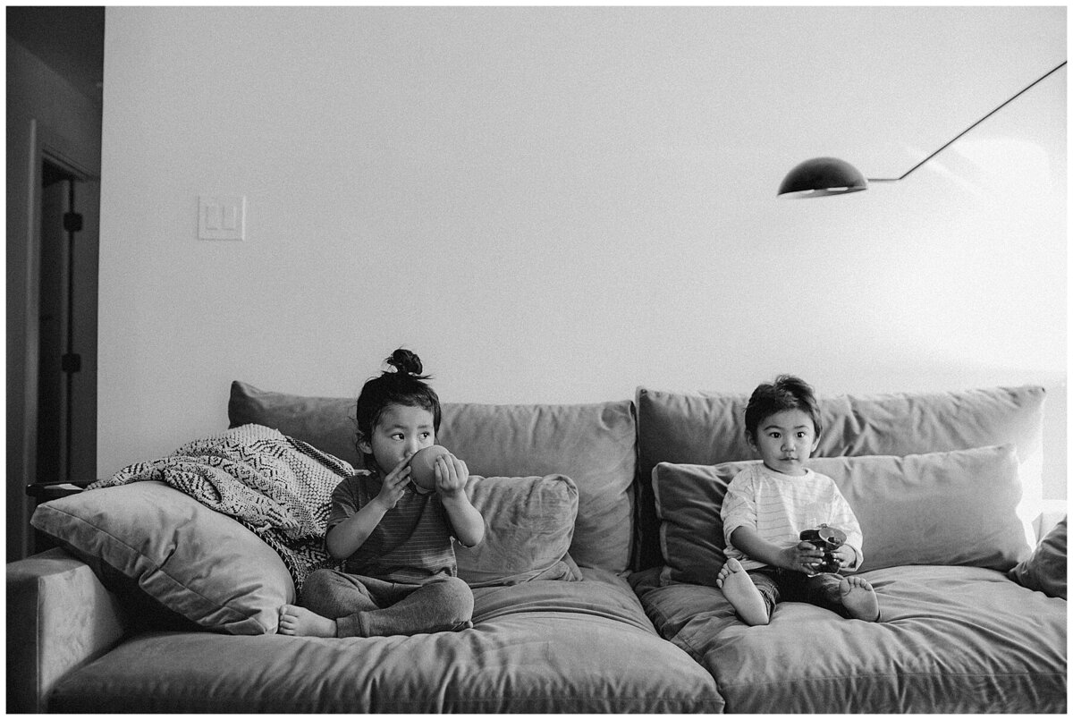 Two children sitting on sofa at family photo session in Austin by Amber Vickey Photography