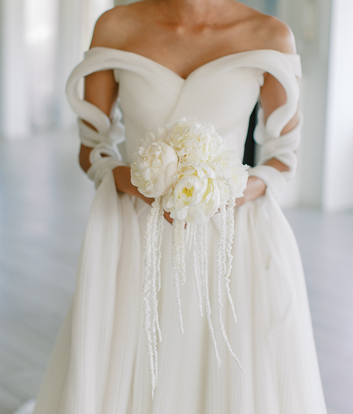 bride holding white flowers