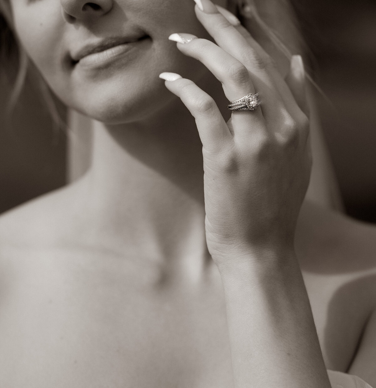 Bride touching face with her wedding ring on