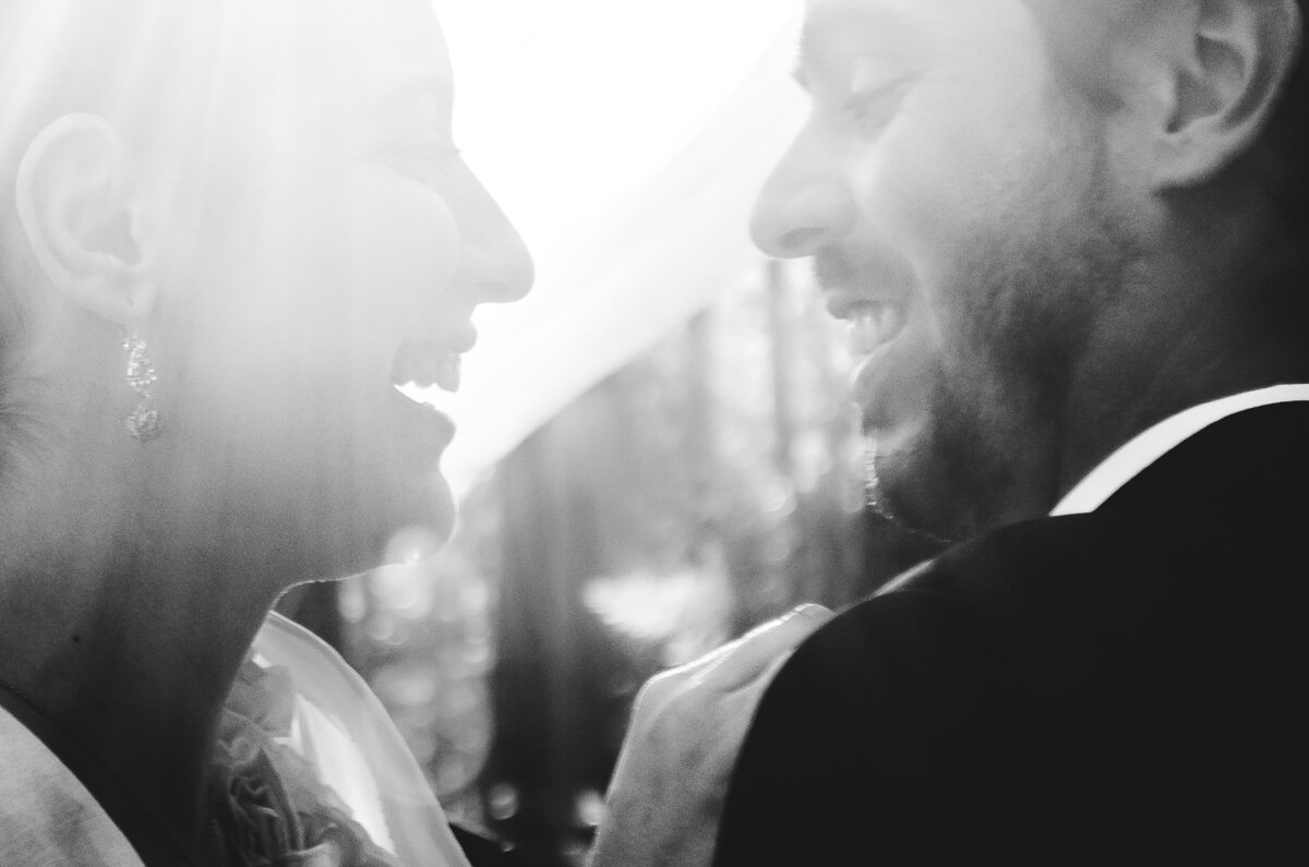 Close up image of bride and groom dancing and smiling to each other
