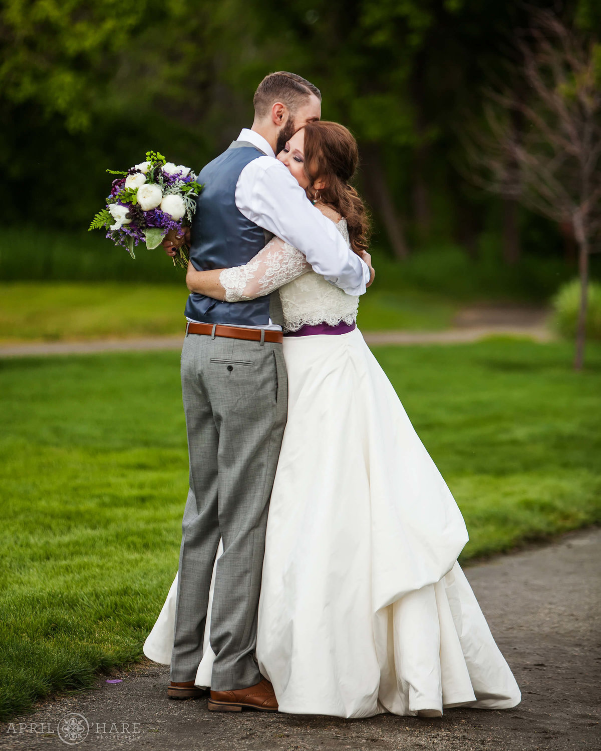 Sweet hug moment after wedding ceremony  at Chatfield Farms in Colorado
