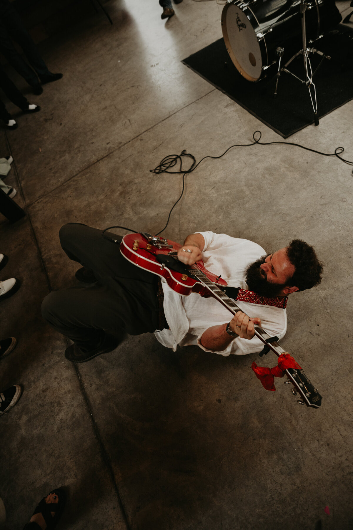 A guitarist rolls on the floor during their set at a wedding at The Shack Revolution. 