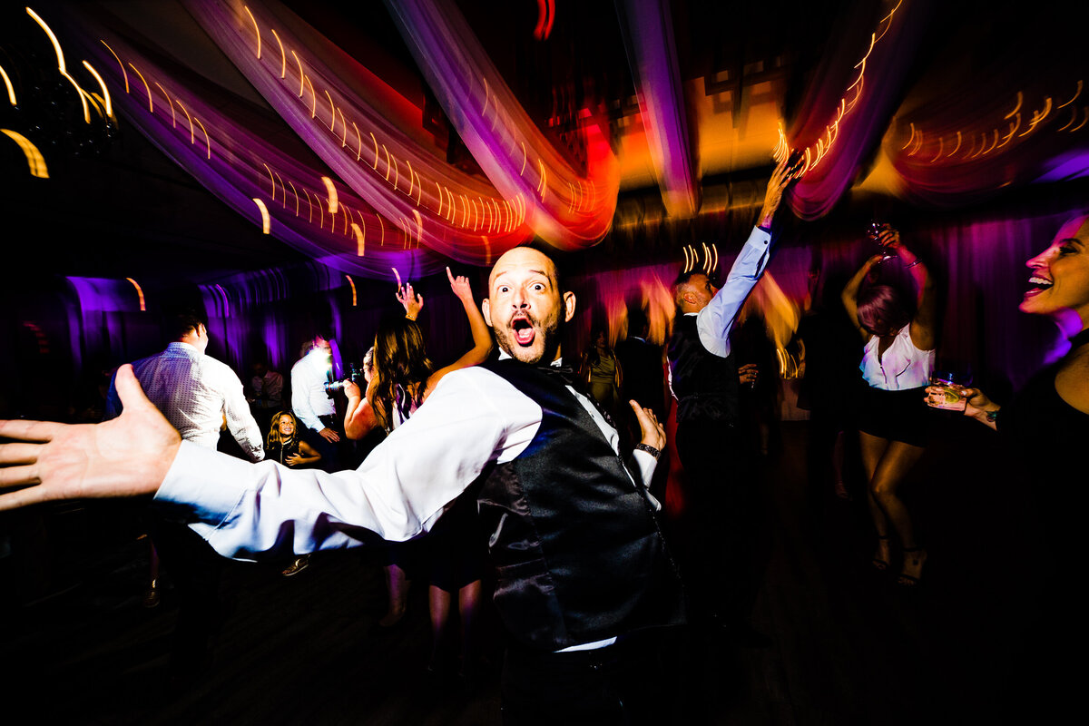 One of the top wedding photos of 2021. Taken by Adore Wedding Photography- Toledo, Ohio Wedding Photographers. This photo is of a groomsman dancing the night away during the wedding reception