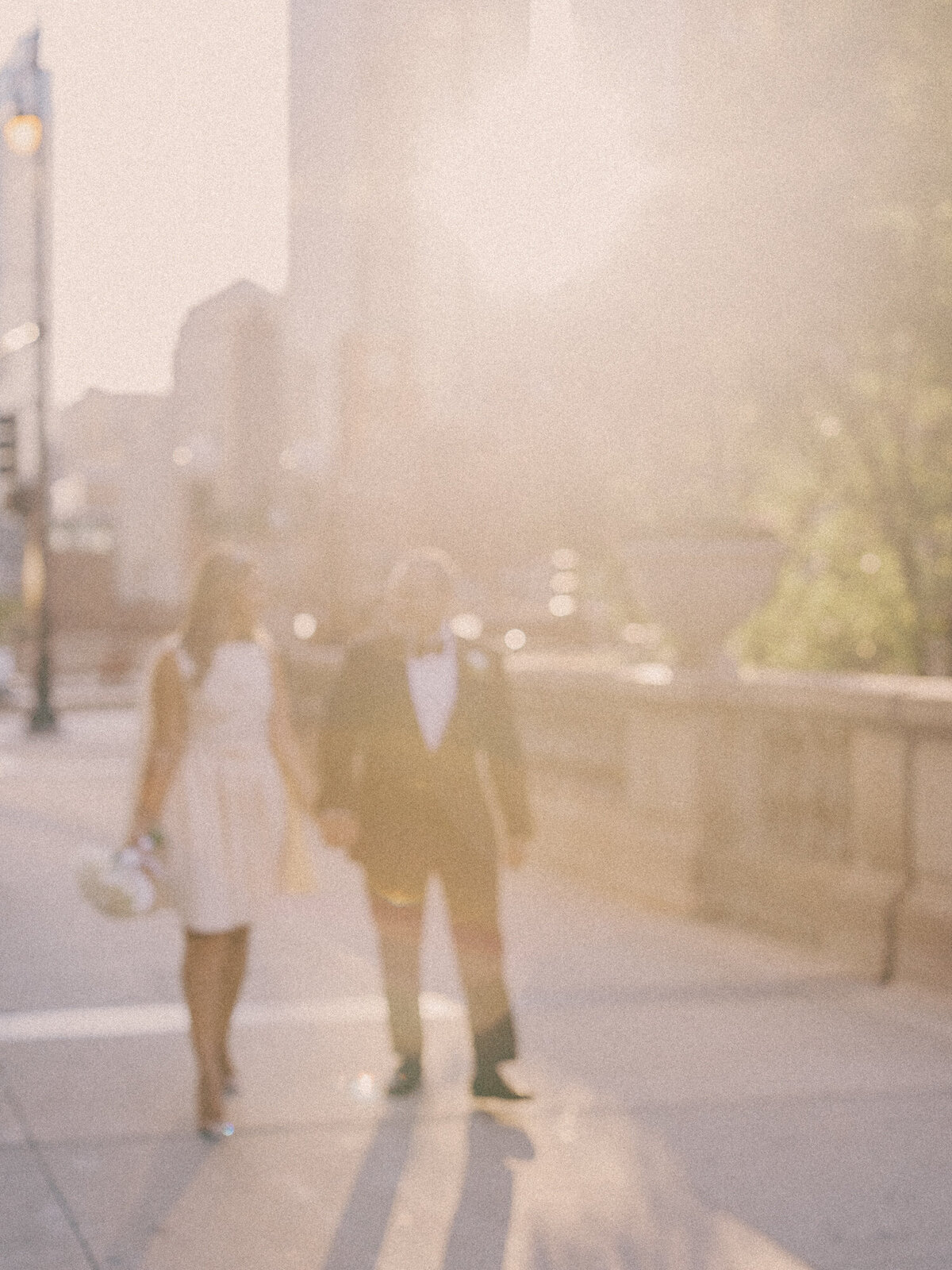 Bride and groom walks along Wacker Drive in Chicago at sunset on their wedding day