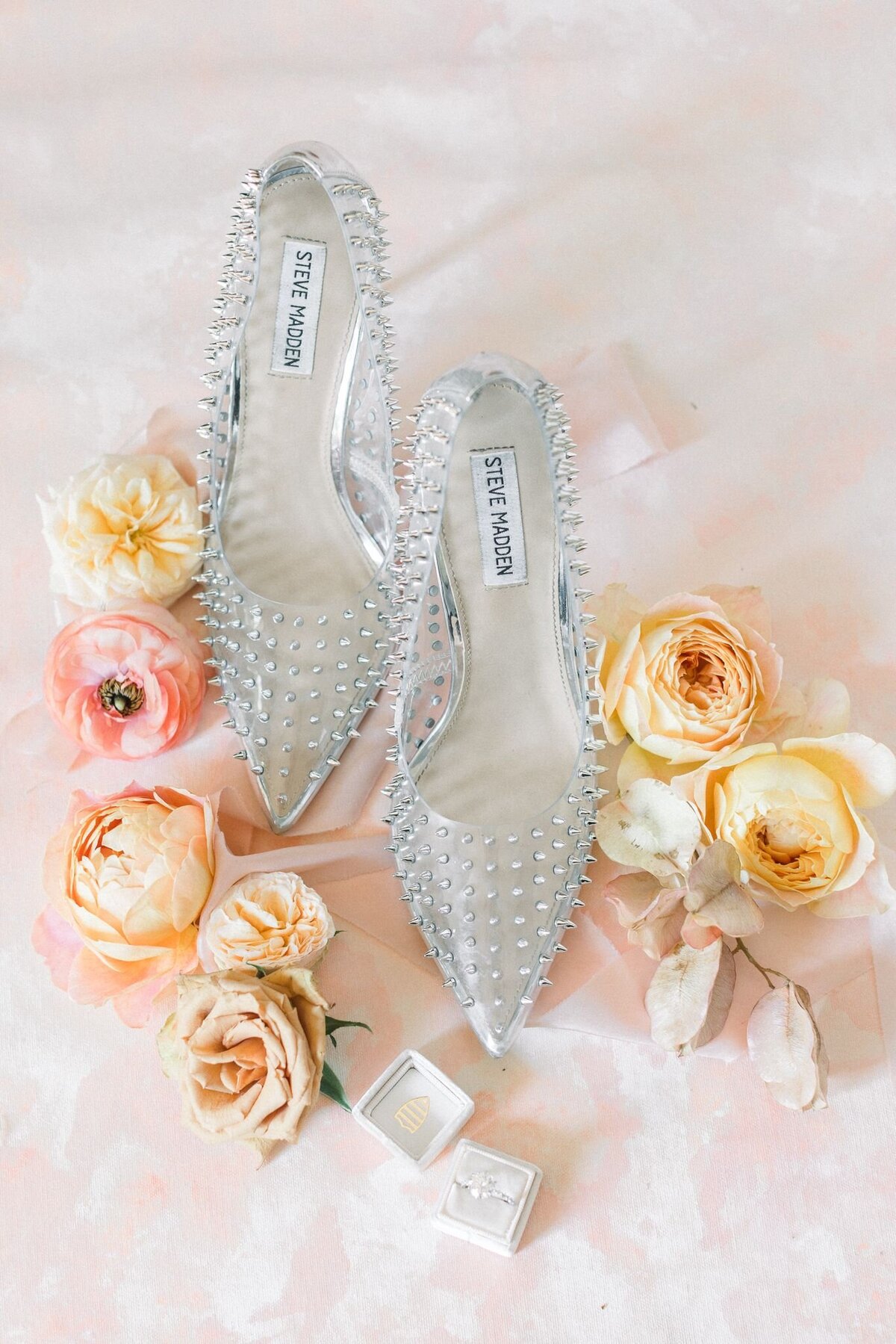 Yellow and pink flowers surround the bride's shoes.
