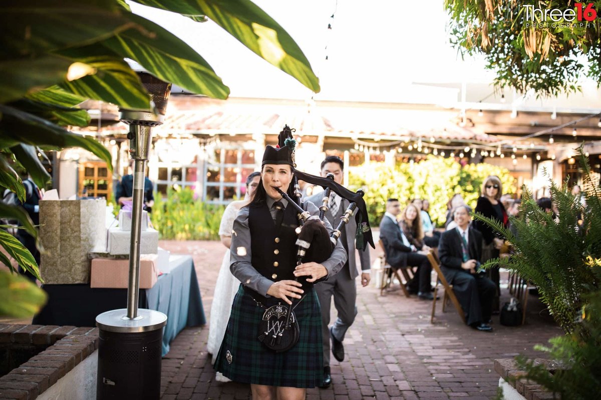 Scottish bagpipes leads the couple into the reception