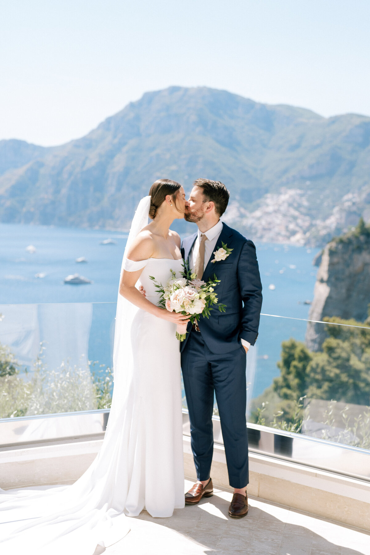 Couple kissing on balcony at Positano wedding