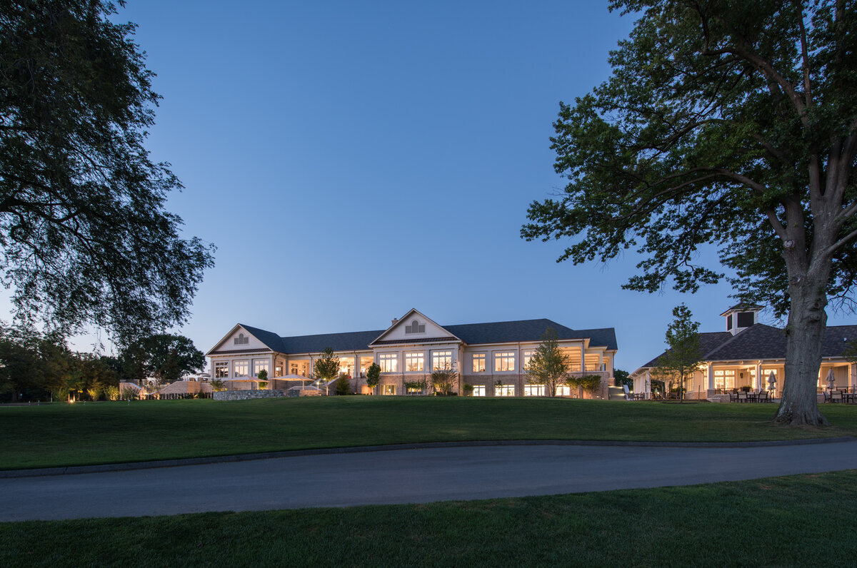 view of clubhouse at night at Woodmont Country Club