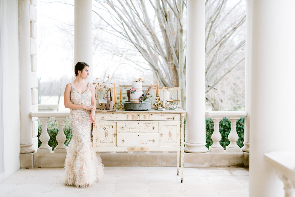 Beautiful Bride posing next to the cake table.