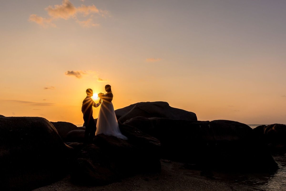 Couple standing on rocks at Sai Nuan beach,| Koh Tao
