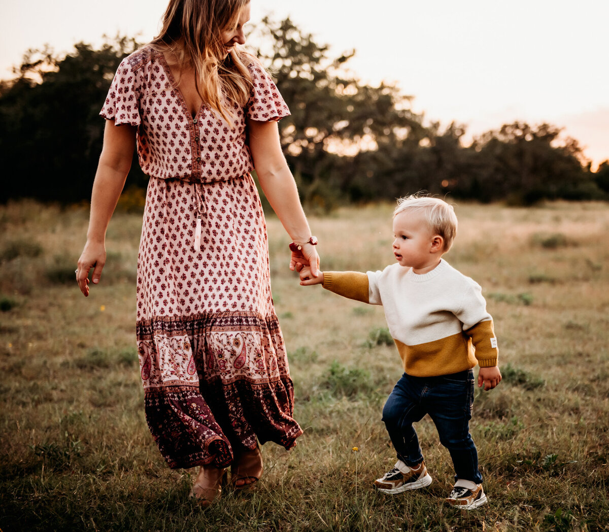 Mom holding little boy's hand and running.