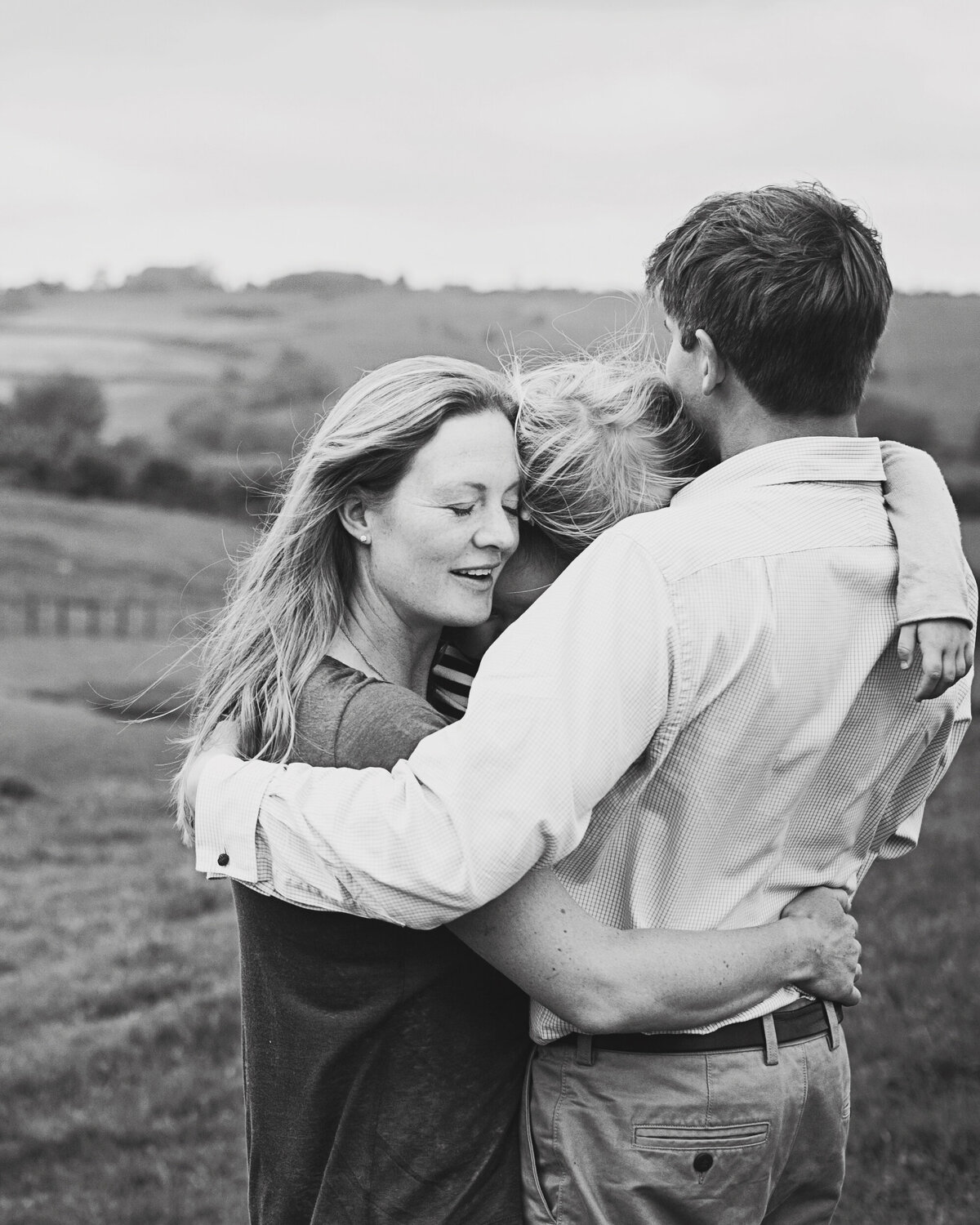 A family embrace for a photograph in the Surrey Hills