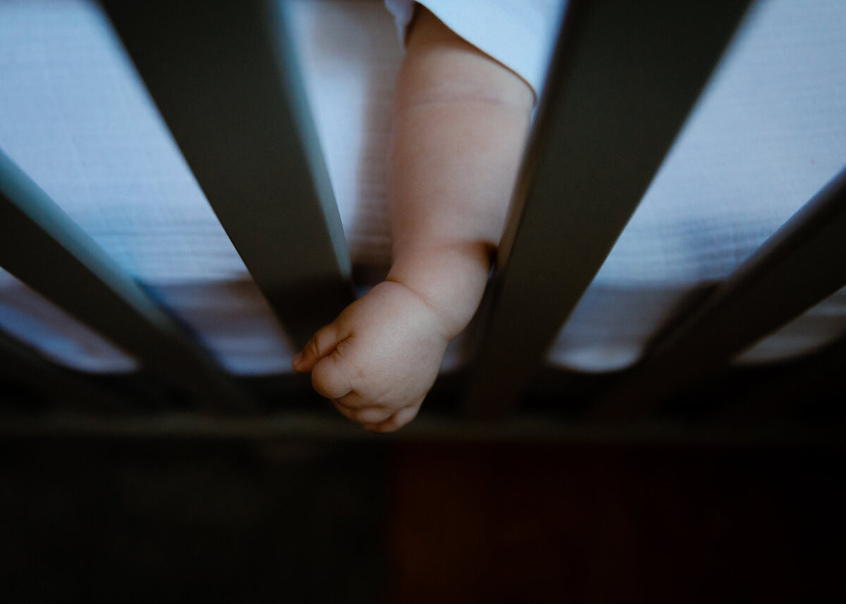 baby-hand-outside-crib
