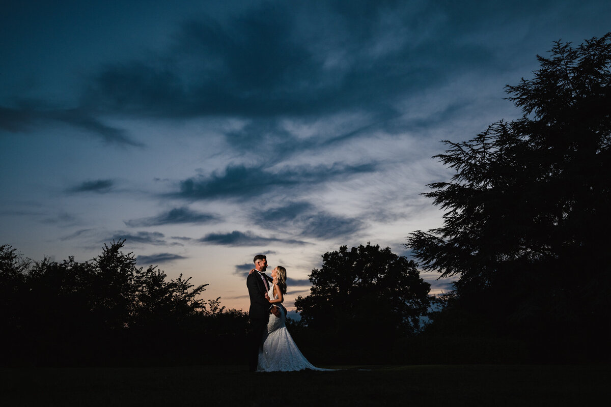 Nightime sunset shot of couple in the grounds of Barton Hall Hotel by Amanda Forman Photography