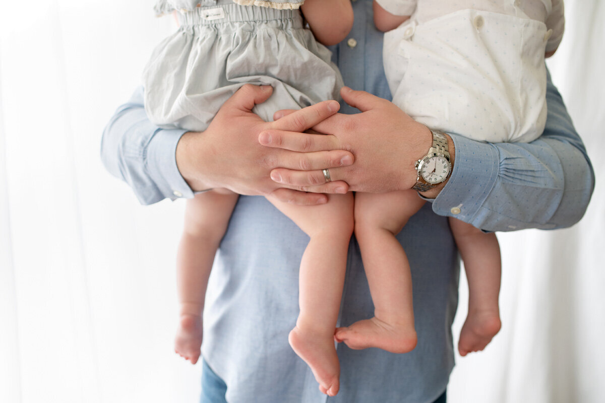 Family session of father holding children