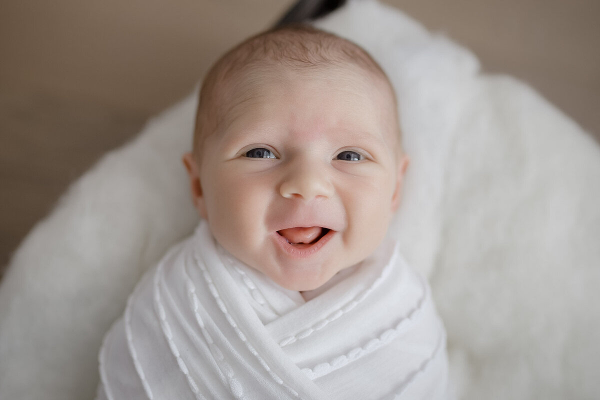 newborn baby smiling