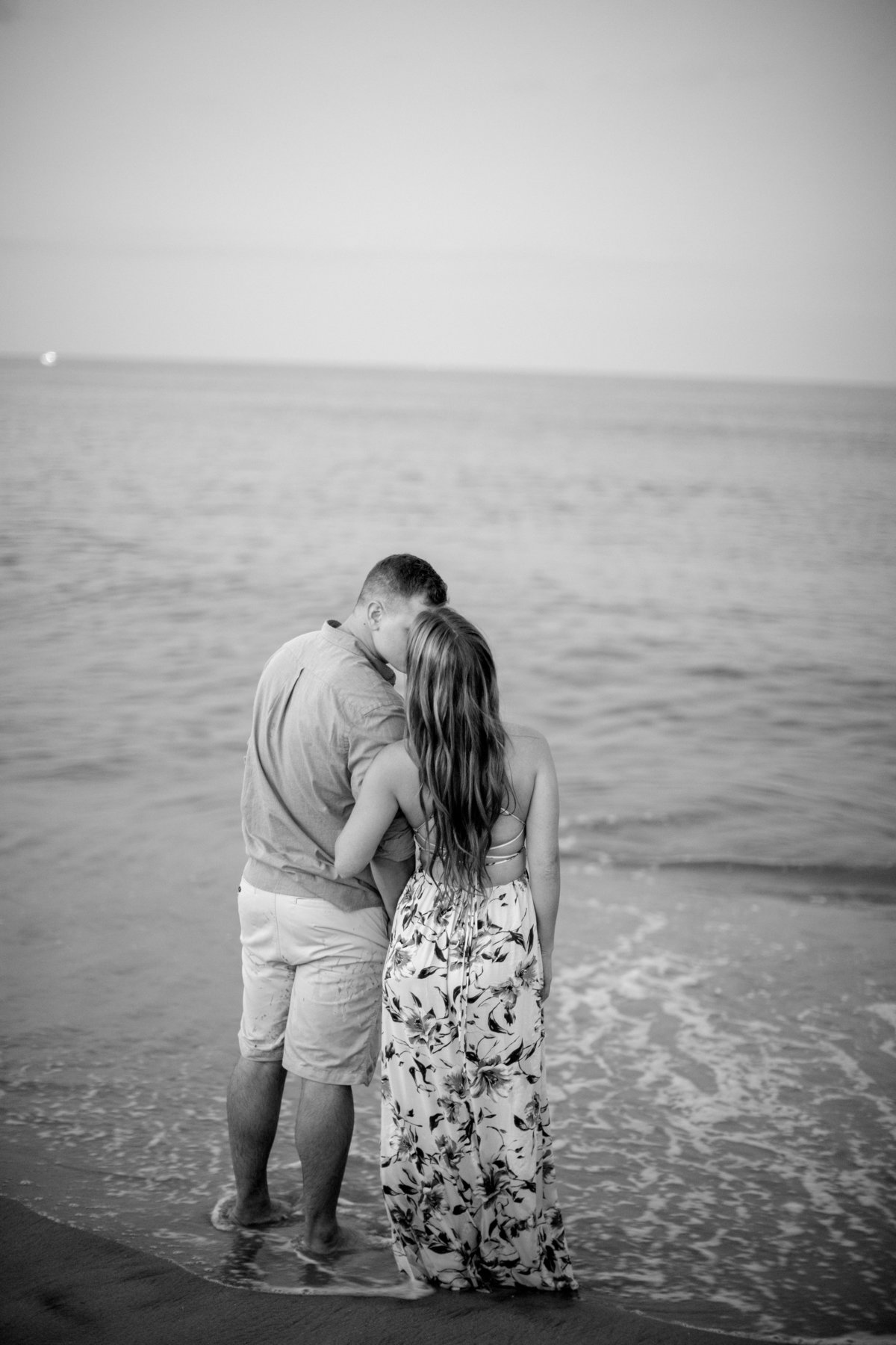 engaged couple kiss by the ocean at manasquan beach