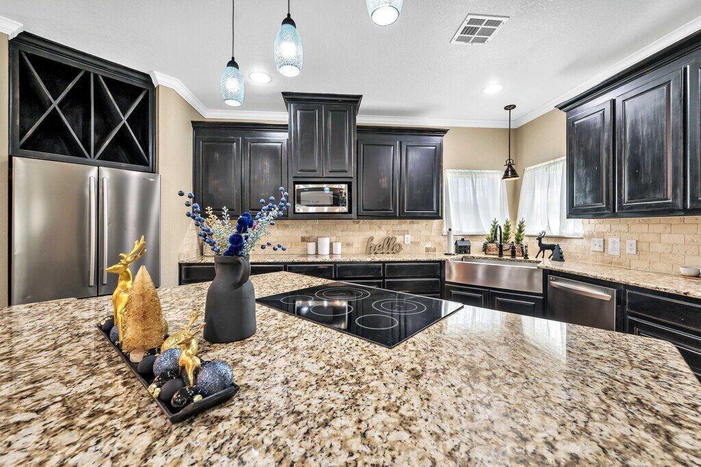 Fully stocked kitchen with large island in this four-bedroom, four-bathroom vacation rental home and guest house with free WiFi, fully equipped kitchen, firepit and room for 10 in Waco, TX.
