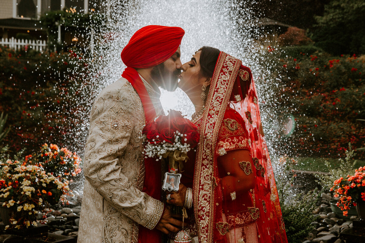 Indian wedding couple posing with fountain