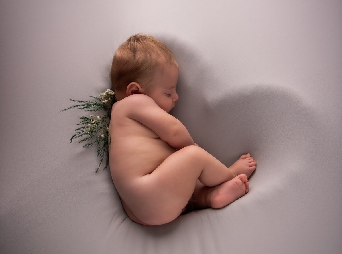 Newborn baby cradled in heart