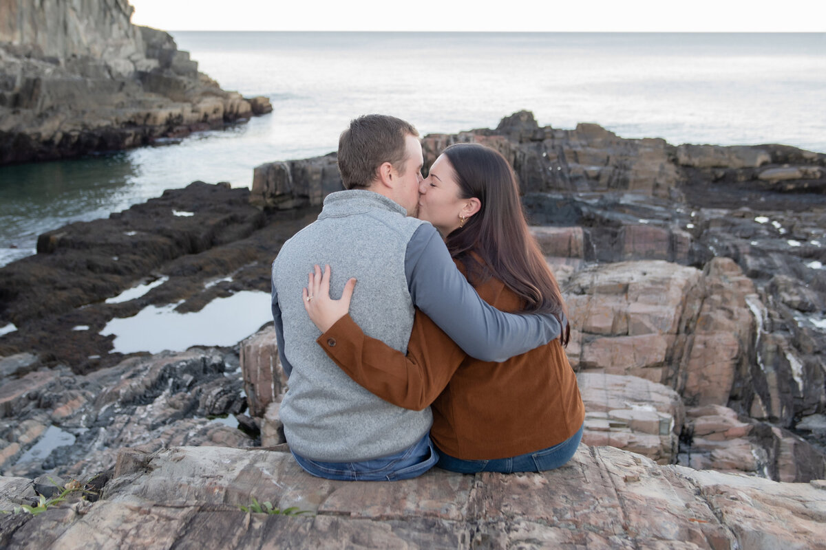 engaged couple kissing at cliff house hotel