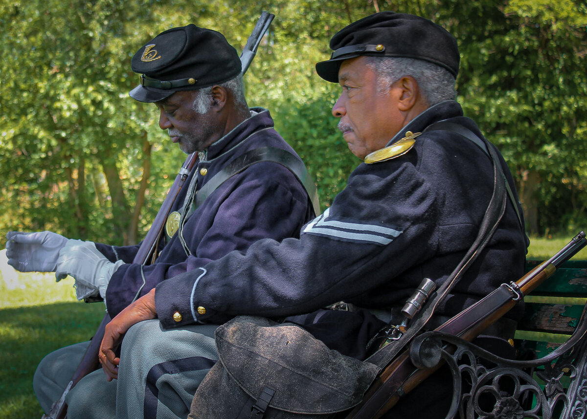 A moment captured while honoring our Serviceman and Servicewomen at Midland Cemetery in Steelton Pennsylvania 2015 Memorial Day Remembrance. Two of the members from the 3rd Regiment U.S. Colored Troops based out of Philadelphia Pennsylvania (Founded August 1863) – Color Sgt. Larry Harris (left) and Cpl. Robert Fuller Houston (right).