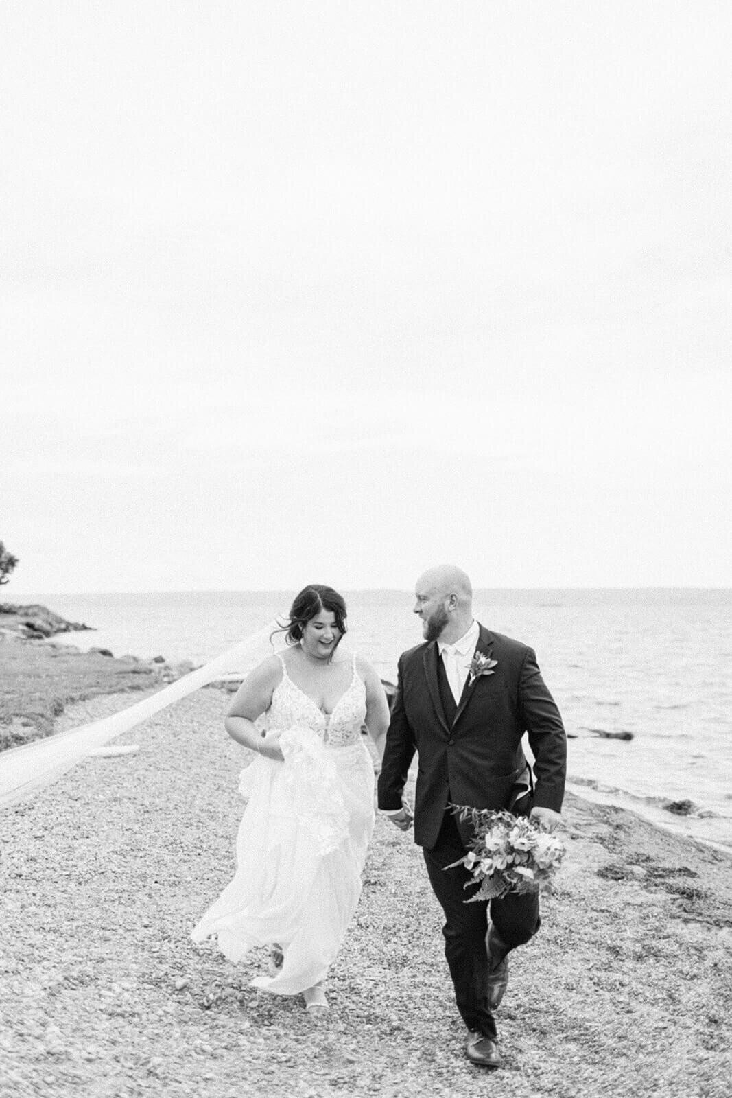 bride-and-groom-running-on-shore