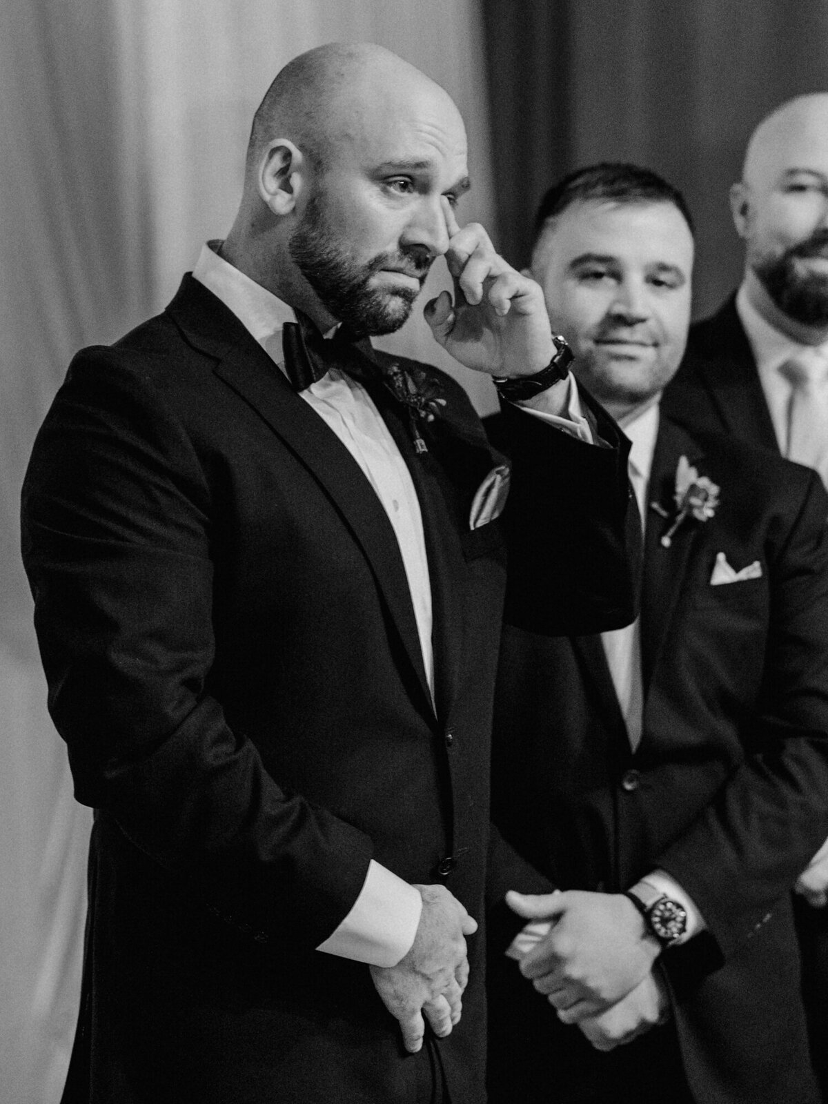 A groom sheds a tear during a wedding ceremony in Chicago