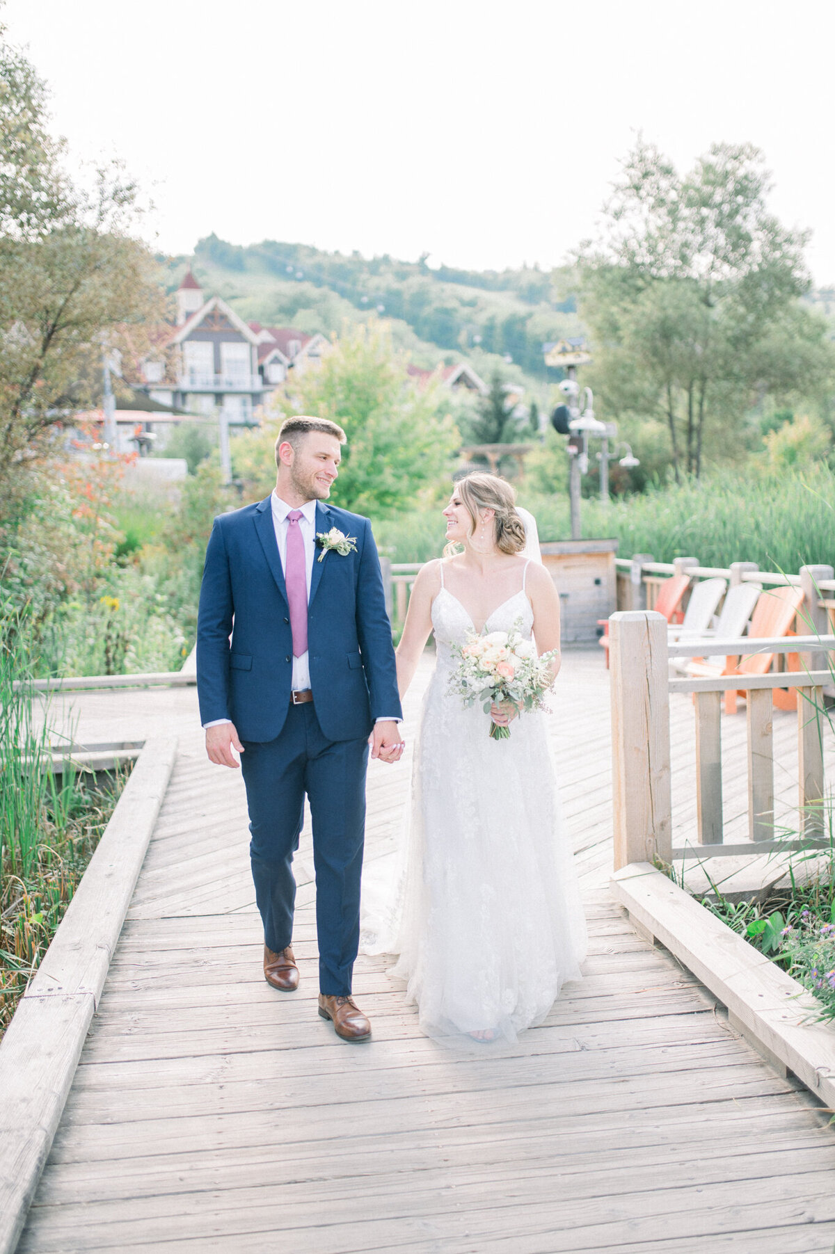 Niagara wedding photography captures bride and groom walking down pier
