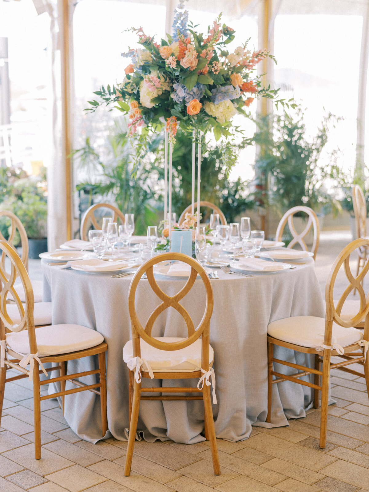 Wedding table with elegant chairs and large floral centerpieces