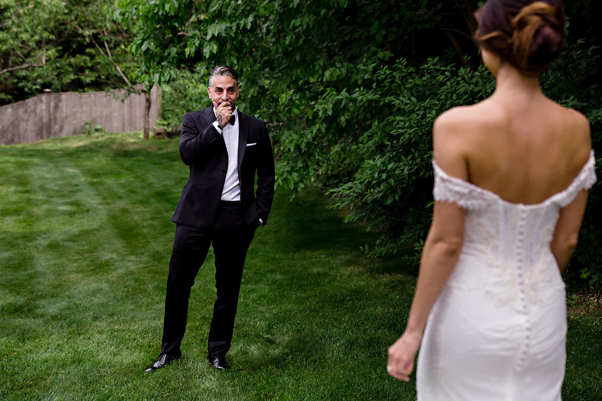 Peabody Essex Museum wedding the groom gets emotional during the couple's first look outside of Boston