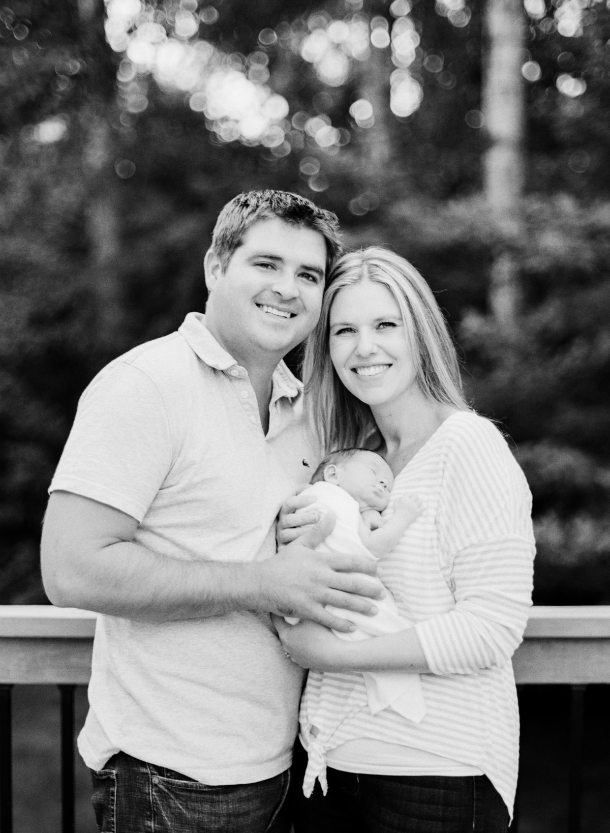 film photography of parents of newborn baby girl in deck of home